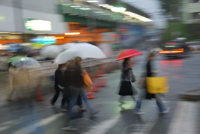 Blurred motion of people walking on road