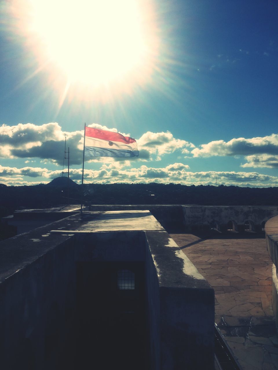 sun, sunbeam, sunlight, lens flare, sky, building exterior, built structure, architecture, sunny, bright, day, cloud, outdoors, house, mountain, cloud - sky, nature, no people, shadow, blue