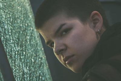 Close-up portrait of a young woman looking away