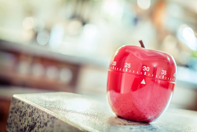 Close-up of apple shape dial on table