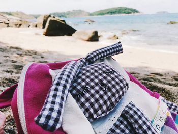 Close-up of bag at shore of beach