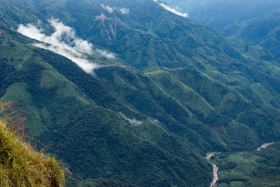 Mountain range downhill peak with light mist at morning from top angle