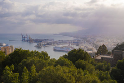 High angle view of buildings and trees against sky