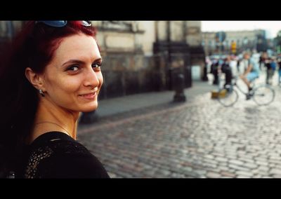 Portrait of smiling young woman in city