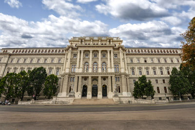 Low angle view of building against cloudy sky