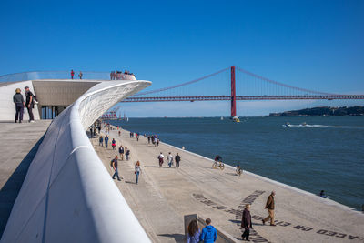 People walking on suspension bridge