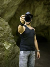 Midsection of woman holding rock