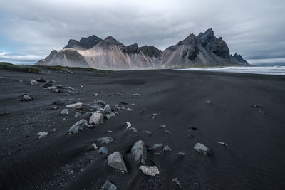 Scenic view of sea and mountains against sky