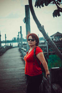 Young woman wearing sunglasses standing outdoors