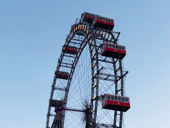 Low angle view of ferris wheel against clear sky