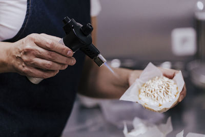 Midsection of man preparing food