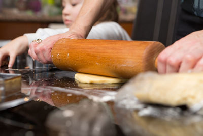 Close-up of man preparing food on table