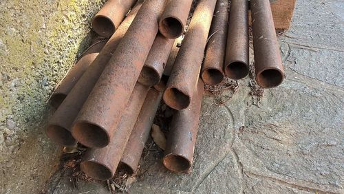 High angle view of rusty pipes by wall