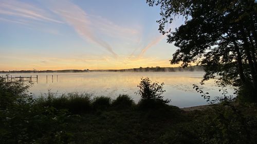 Scenic view of lake against sky during sunset