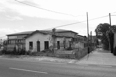 Empty road along buildings