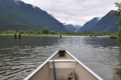 Scenic view of lake by mountains against sky