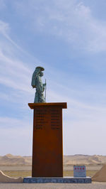 Low angle view of statue against sky