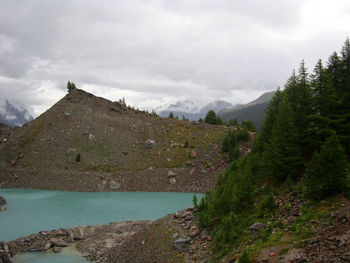 Scenic view of sea and mountains against sky