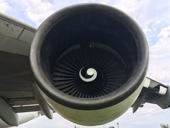 Close-up of airplane wheel against sky