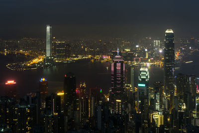 Illuminated cityscape against sky at night