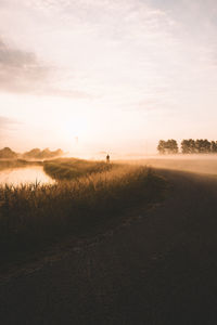 Scenic view of field against sky during sunrise