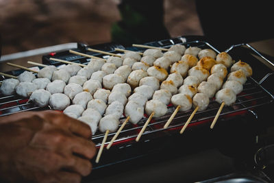 High angle view of person preparing food on barbecue grill