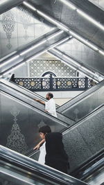 Low angle view of man standing on escalator