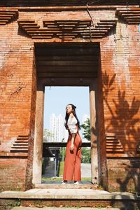 Woman standing against building