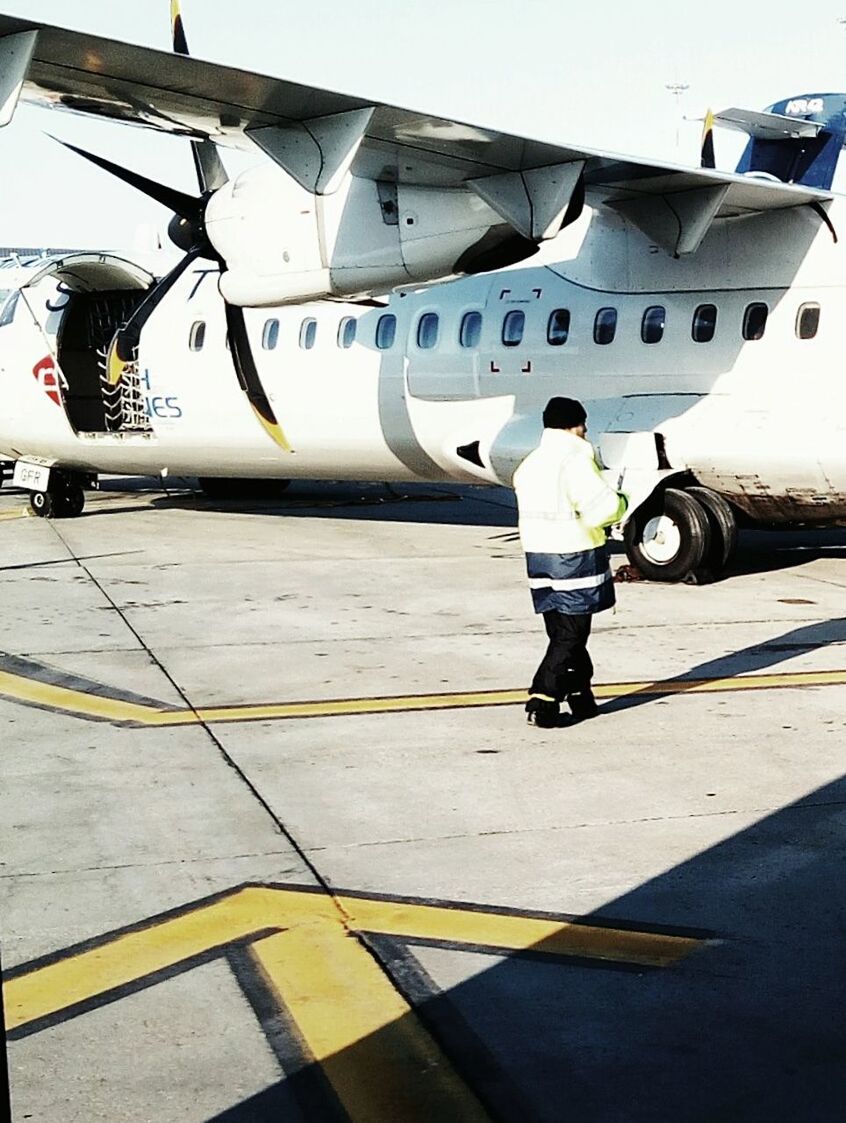 MAN WORKING ON AIRPLANE