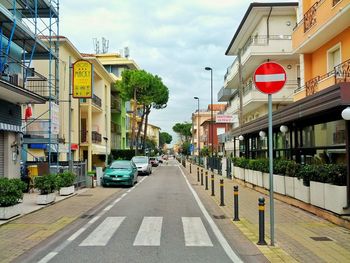 Vehicles on road along buildings