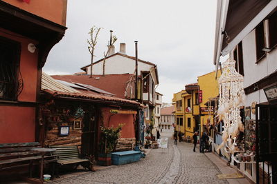 Street amidst buildings in town against sky