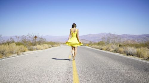 Woman walking on country road