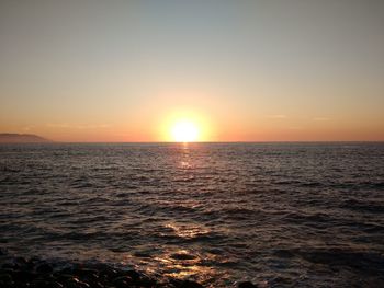 Scenic view of sea against clear sky during sunset