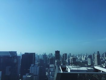Cityscape against clear blue sky