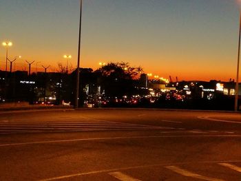 Illuminated road against sky at night