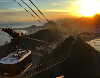 Overhead cable car against mountains during sunset