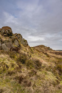 Rock formations on landscape against sky