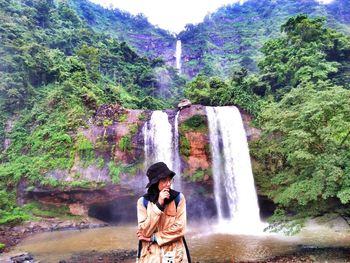 Full length of waterfall in forest