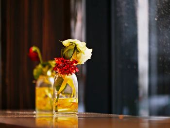 Close-up of flower vase on glass table