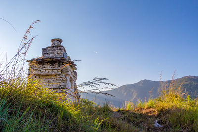 Built structure on field against clear sky