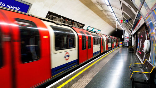 Blurred motion of train at railroad station