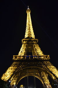 Low angle view of illuminated tower against sky at night