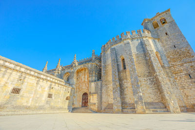 Low angle view of historical building against clear blue sky