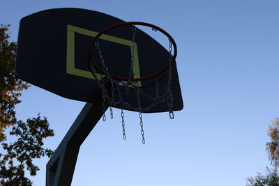 Low angle view of basketball hoop against clear blue sky