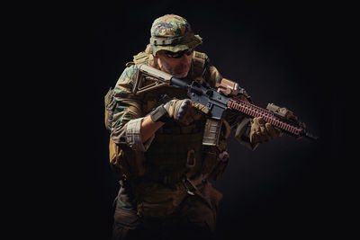 Mature man in military uniform against black background