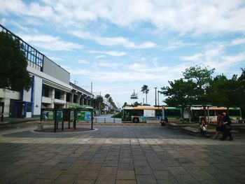 Street amidst buildings against sky in city