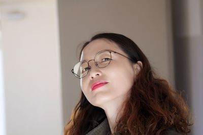 Portrait of confident young woman wearing eyeglasses