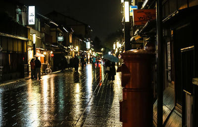 Wet illuminated city during rainy season at night