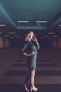 Full length of woman standing in underground walkway