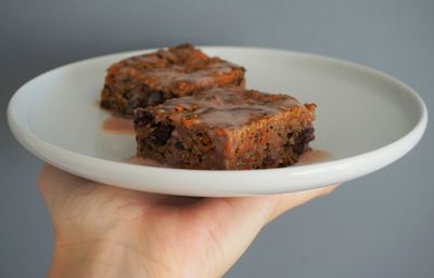 Close-up of hand holding food in plate